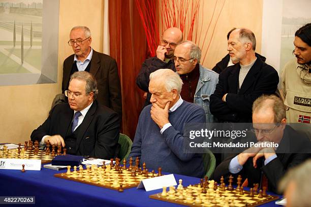 Paolo Fresco, former CEO of Fiat, sits in front of a chessboard thinking about his next at the Centro Congressi of the Industrial Union, in the...