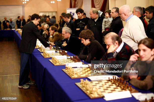 Italo-american Fabiano Caruana, Italian chess champion in office, makes his move during a synchronized piece play he is playing with the players of...