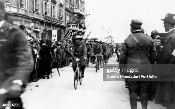 Volunteer Italian Bersaglieri division parading by bicycle in the streets of the city. Rijeka, 1919