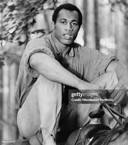 American boxer and actor Ken Norton in the saddle of a horse acting in the film Mandingo. 1975