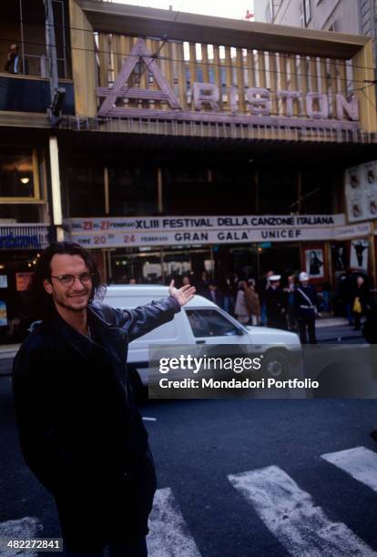 Italian singer-songwriter Biagio Antonacci pointing out the Ariston Theatre where the 43rd Sanremo Music Festival is staged. Sanremo, February 1993