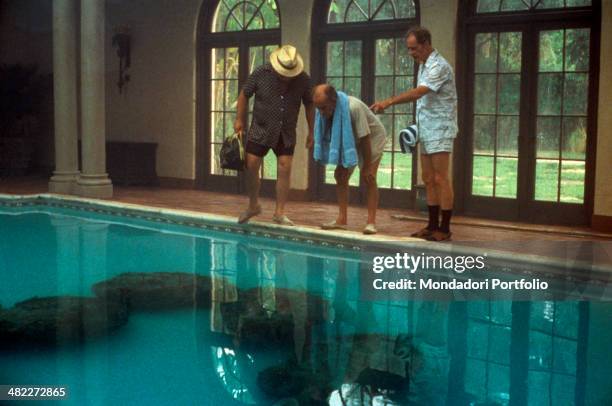 American actors Wilford Brimley, Hume Cronyn and Don Ameche observing the cocoons laid down by the aliens in a swimming pool in the film Cocoon. 1985