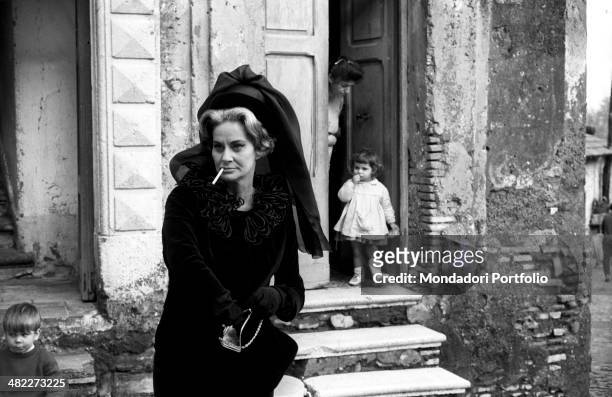 Italian actress Alida Valli dressed in mourning and smoking a cigarette in the film Umorismo in nero. Italy, 1964