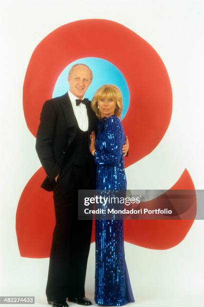 Italian actress and TV presenter Sandra Mondaini and her husband and Italian actor and TV host Raimondo Vianello hugging each other in the studio of...