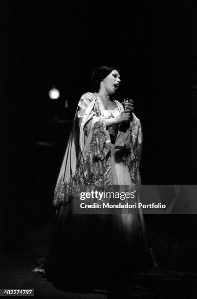 Italian soprano Mirella Freni acting in the opera La Traviata with a glass in the hands. Milan, 1964