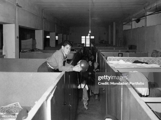 Istrian refugees posing in a dormitory at Risiera di San Sabba. Trieste, 1950s