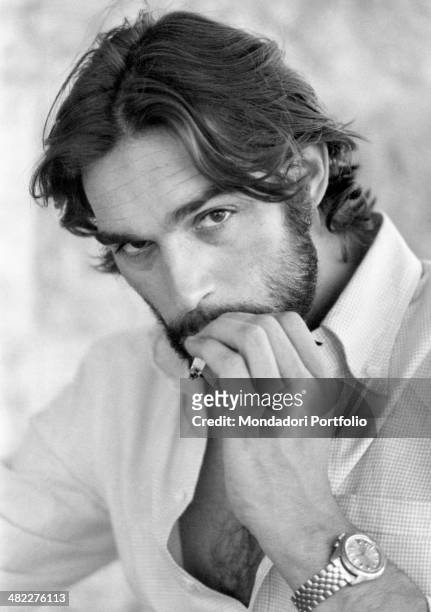 Italian actor and singer Fabio Testi smoking a cigarette. Peschiera del Garda, 1971