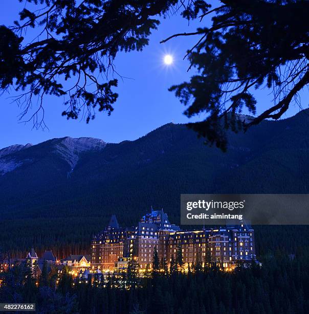 fairmont banff springs hotel with moon - banff national park stock pictures, royalty-free photos & images