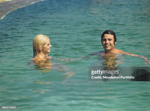 Sammarinese singer Little Tony swimming with Italian actress and model Silvia Dionisio. Porto Cervo, 1968