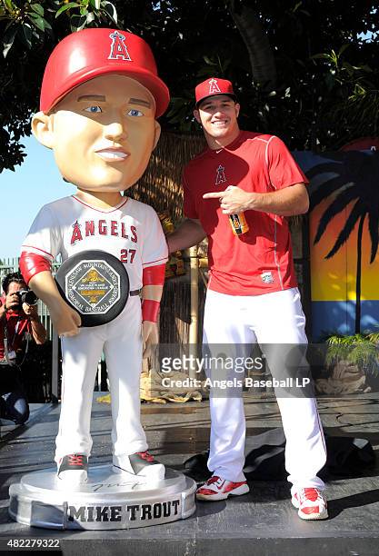 Mike Trout of the Los Angeles Angels of Anaheim poses with a life-sized bobblehead made in his likeness commemorating his 2014 American League MVP...