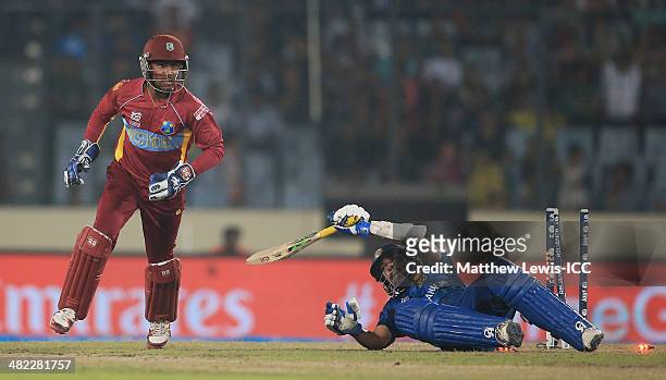 Tillakaratne Dilshan of Sri Lanka is run out by Lendl Simmons of the West Indies, as Denesh Ramdin looks on during the ICC World Twenty20 Bangladesh...