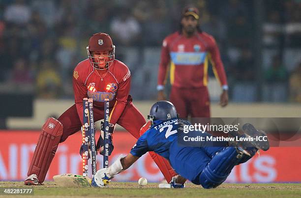 Tillakaratne Dilshan of Sri Lanka is run out by Lendl Simmons of the West Indies, as Denesh Ramdin looks on during the ICC World Twenty20 Bangladesh...