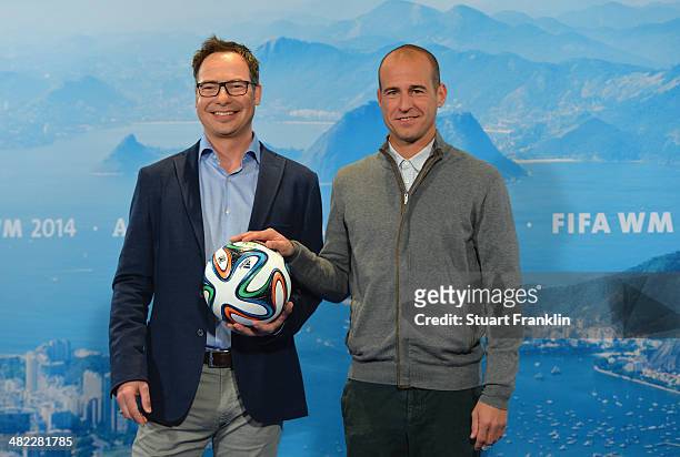 Television presenter Matthias Opdenhoevel is pictured with football expert Mehmet Scholl during the ARD/ZDF FIFA World Cup 2014 team presentation...