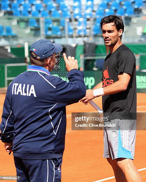 Fabio Fognini of Italy takes advice from a coach during a practice session prior to the Davis Cup World Group Quarter Final match between Italy and...