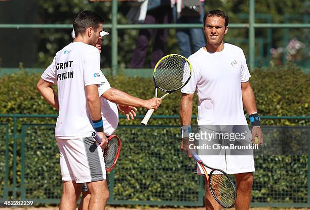 Doubles pairing of Colin Fleming and Ross Hutchins of Great Britain listen to advice from their coach during practice after the main draw ceremony...