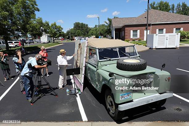 Painter Mark Balma paints a portrait of Cecil the lion to donate to anti-poaching efforts in the parking lot of Dr. Walter Palmer's dental clinic on...