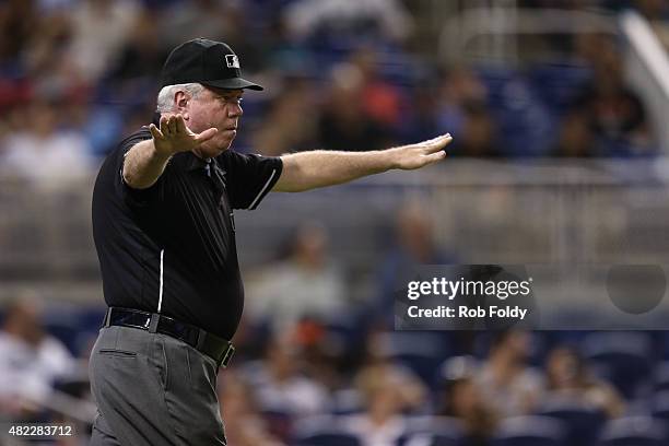 Umpire Brian Gorman in action making the safe sign during the game between the Miami Marlins and the St. Louis Cardinals at Marlins Park on June 23,...