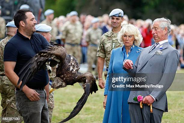 Prince Charles, Prince of Wales and Camilla, Duchess of Cornwall react as Zephyr, a Bald Eagle, and mascot of The Army Air Corps flaps it's wings as...