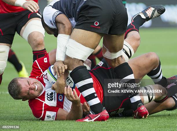 Michael Broadhurst of Japan, bottom gets tackled against Fiji during their World Rugby Pacific Nations Cup match in Toronto, Canada July 29, 2015....