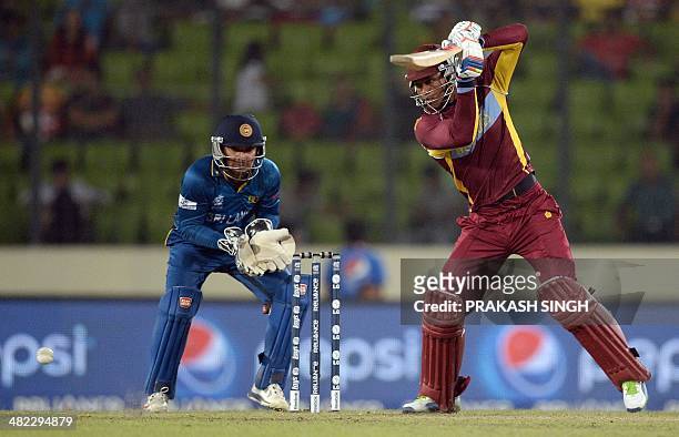 Sri Lanka wicketkeeper Kumar Sangakkara watches as West Indies batsman Marlon Samuels plays a shot during the ICC World Twenty20 cricket tournament...