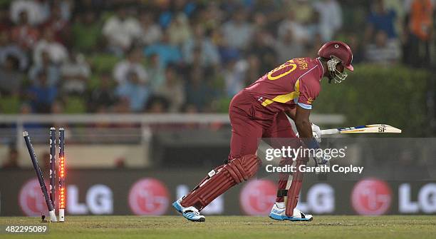 Dwayne Smith of the West Indies is bowld by Lasith Malinga of Sri Lanka during the ICC World Twenty20 Bangladesh 2014 semi final between Sri Lanka...