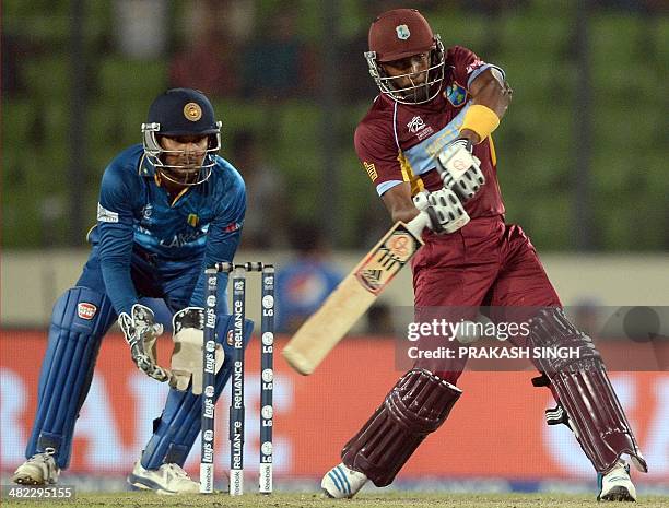Sri Lanka wicketkeeper Kumar Sangakkara watches as West Indies batsman Dwayne Bravo plays a shot during the ICC World Twenty20 cricket tournament...