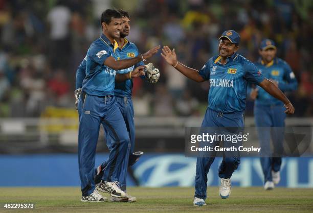 Nuwan Kulasekara of Sri Lanka celebrates with Rangana Herath of Sri Lanka after dismissing Dwayne Bravo of the West Indies during the ICC World...