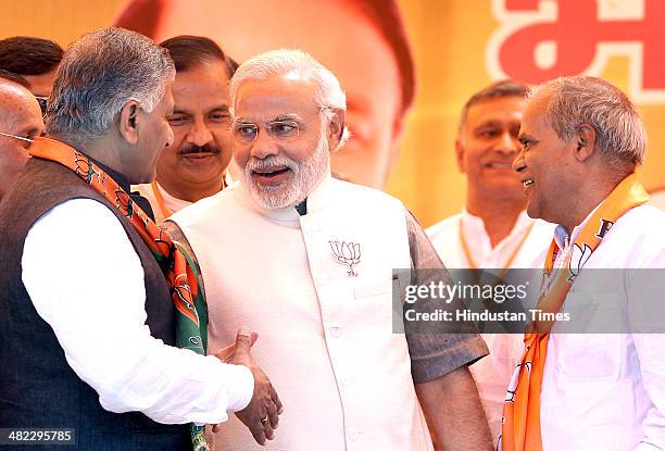 Former Congress leader Ramesh Chand Tomar greeted by BJP Prime Ministerial candidate Narendra Modi during an election rally in the support of...