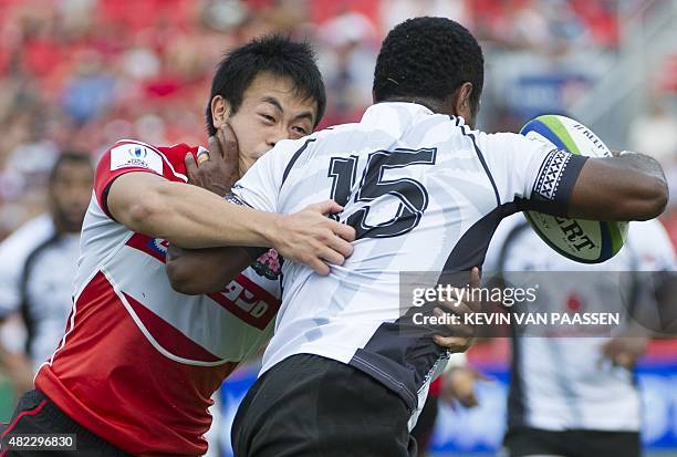 Kenki Fukuoka of Japan, left, attempts to tackle Kini Murimurivalu of Fiji during their World Rugby Pacific Nations Cup match in Toronto, Canada July...