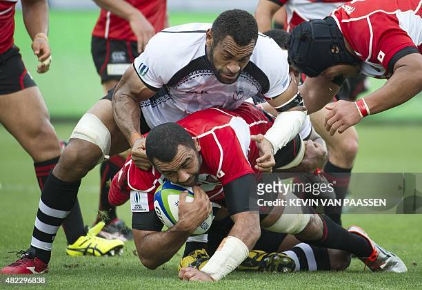 Malakai Ravulo of Fiji, top, competes against Michael Leitch of Japan during their World Rugby Pacific Nations Cup match in Toronto, Canada July 29,...