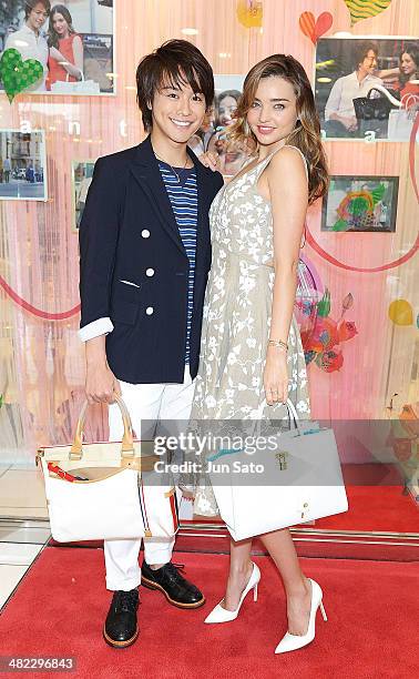 Miranda Kerr and Takahiro of EXILE pose for a photograph at Samantha Thavasa Omotesando Gates Store on April 3, 2014 in Tokyo, Japan.