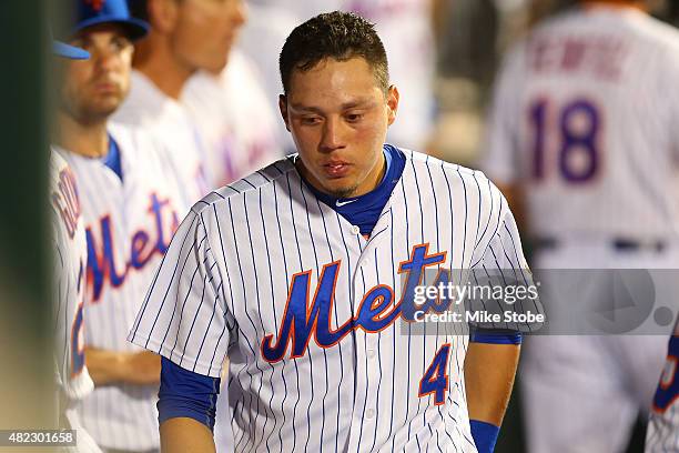 Wilmer Flores of the New York Mets looks on in the dugout in the ninth inning duirng the game against the San Diego Padres at Citi Field on July 29,...