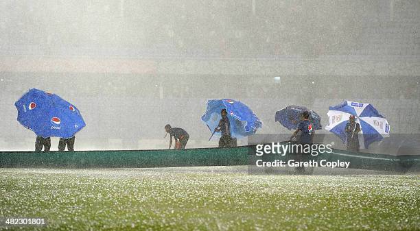 Groundstaff stuggle to cover the field as a storm stops play during the ICC World Twenty20 Bangladesh 2014 semi final between Sri Lanka and the West...