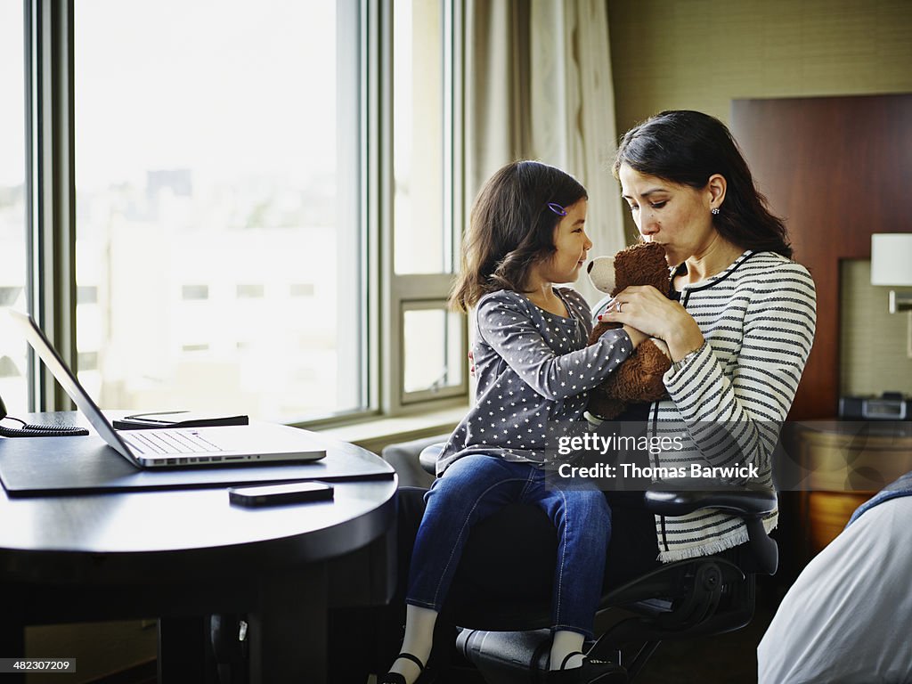 Businesswoman in hotel room with daughter