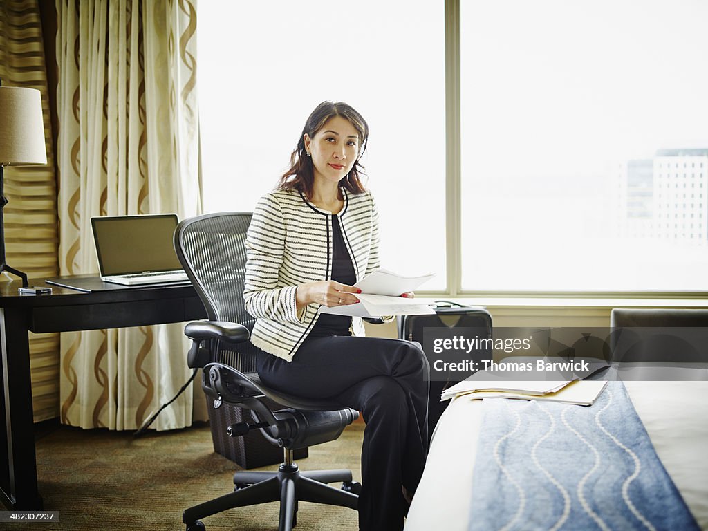 Smiling businesswoman sitting in hotel room