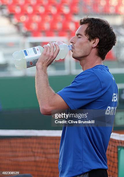 Andy Murray of Great Britain takes a drink during a late practice session prior to the Davis Cup World Group Quarter Final match between Italy and...
