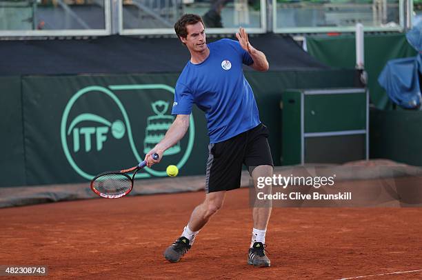 Andy Murray of Great Britain plays a forehand during a late practice session prior to the Davis Cup World Group Quarter Final match between Italy and...