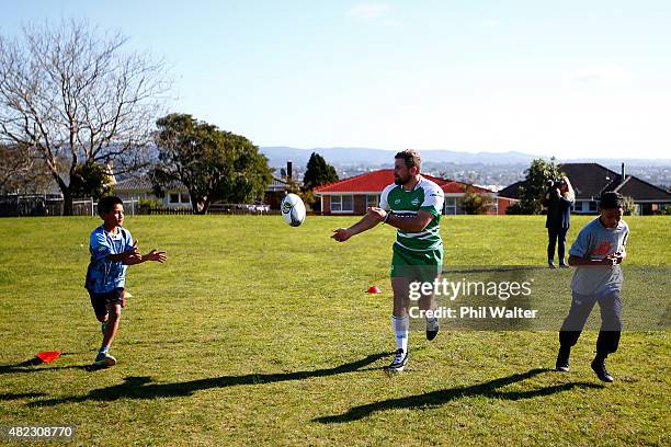 Callum Gibbons of Manawatu coaches rugby to children at New Windsor School following the 2015 ITM Cup season launch at New Windsor School on July 30,...