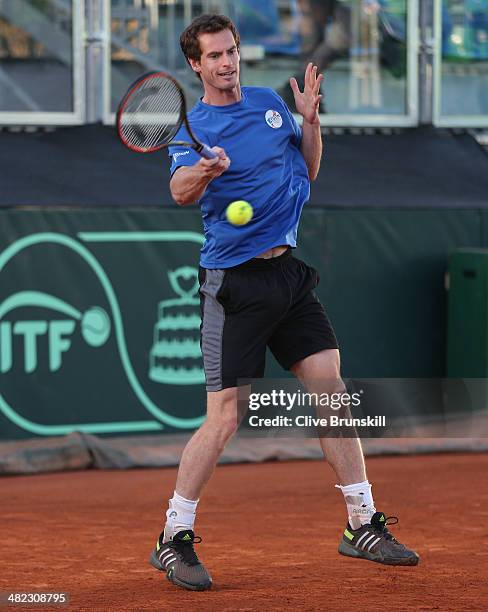 Andy Murray of Great Britain plays a forehand during a late practice session prior to the Davis Cup World Group Quarter Final match between Italy and...