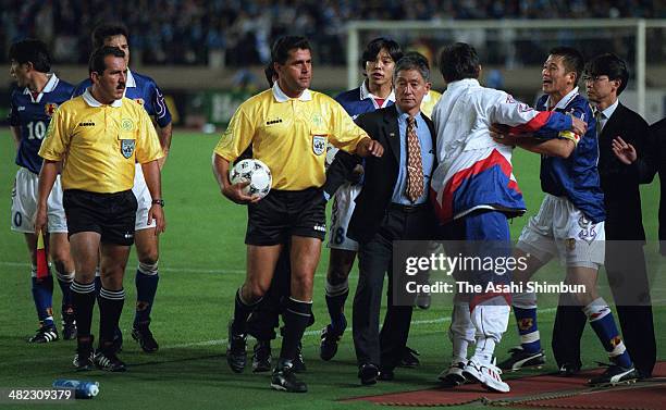 Kazuyoshi Miura of Japan is stopped to appeal to the referees by head coach Takeshi Okada after the France World Cup Asian Qualifier final round...