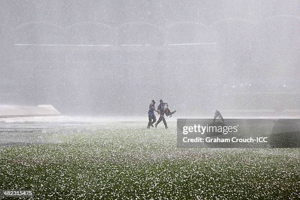 Groundstaff work through a hailstorm that hit the game between Sri Lanka v West Indies at Sher-e-Bangla Mirpur Stadium during the ICC World Twenty20...