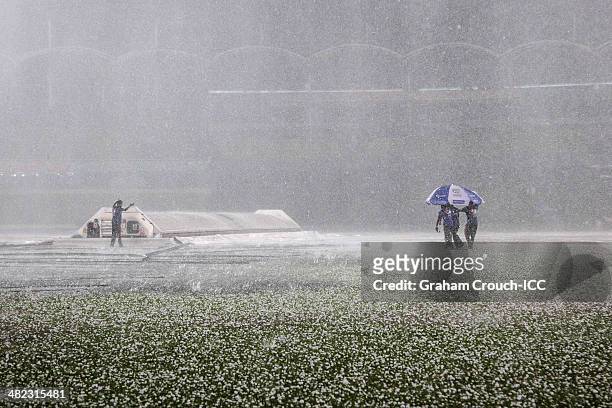 Groundstaff work through a hailstorm that hit the game between Sri Lanka v West Indies at Sher-e-Bangla Mirpur Stadium during the ICC World Twenty20...