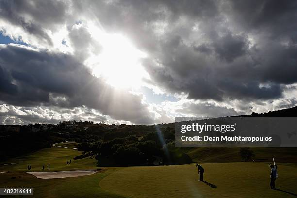 Tom Lewis of England hits putts on the 9th green as the sun breaks through the clouds during day one of the NH Collection Open held at La Reserva de...