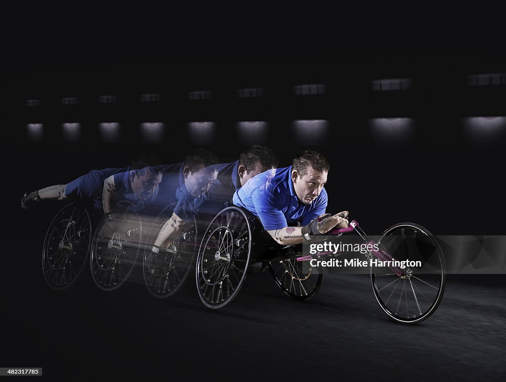 Disabled athlete racing in wheelchair.