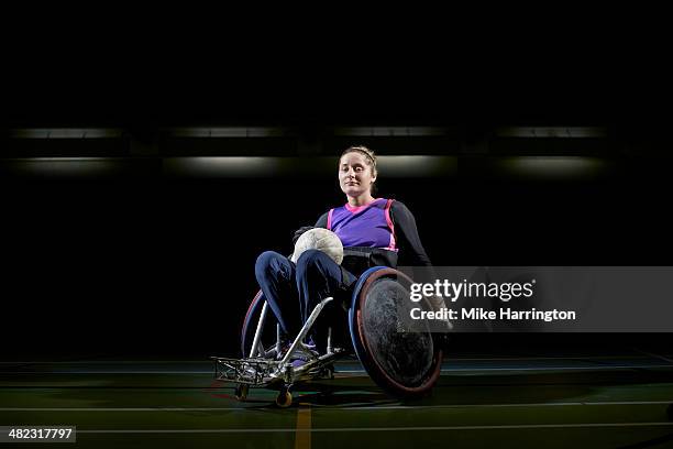 female wheelchair rugby player ready for action - wheelchair rugby stockfoto's en -beelden