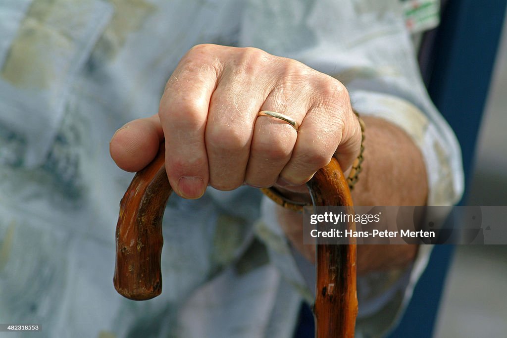 Hand of a man on walking stick