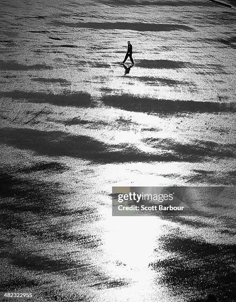 An umpire walks out to inspect the flooded field after heavy rain drenched the ground during the ICC World Twenty20 Bangladesh 2014 1st Semi-Final...