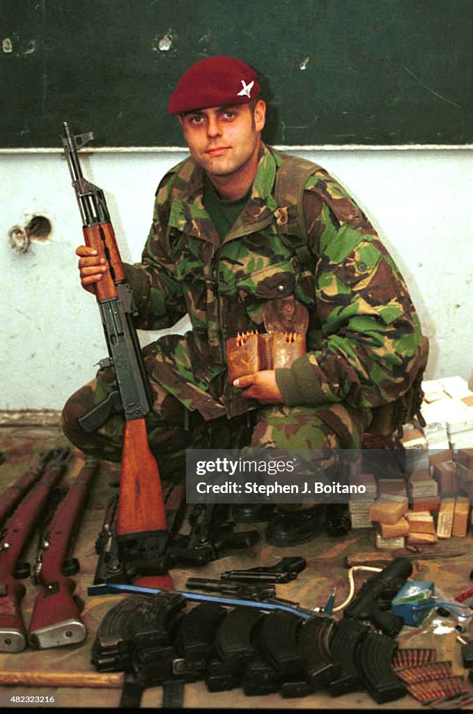 British Paratroopers pose with captured  weapons in Pristina...