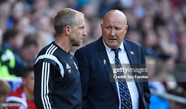 Cardiff manager Russell Slade chats with assistant Paul Trollope chat before the Pre season friendly match between Cardiff City and Watford at...