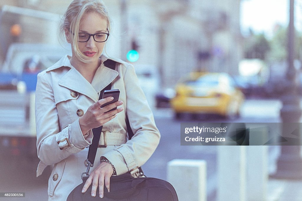 Young businesswoman using a mobile phone in the urban environmen